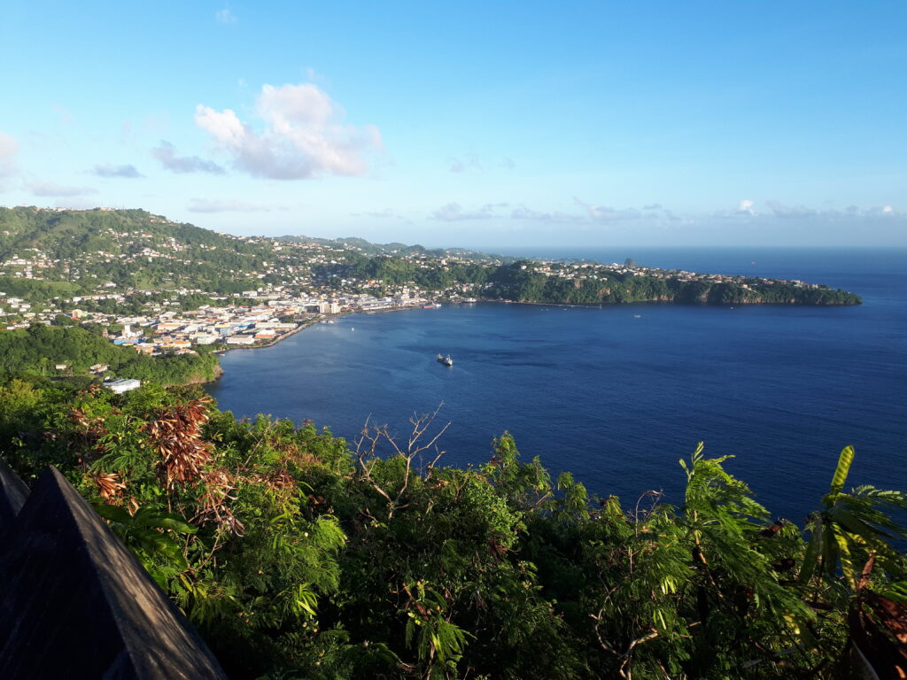 grass covered hills, settlements and the bay at Kingstown, St Vincent and the Caribbean Sea