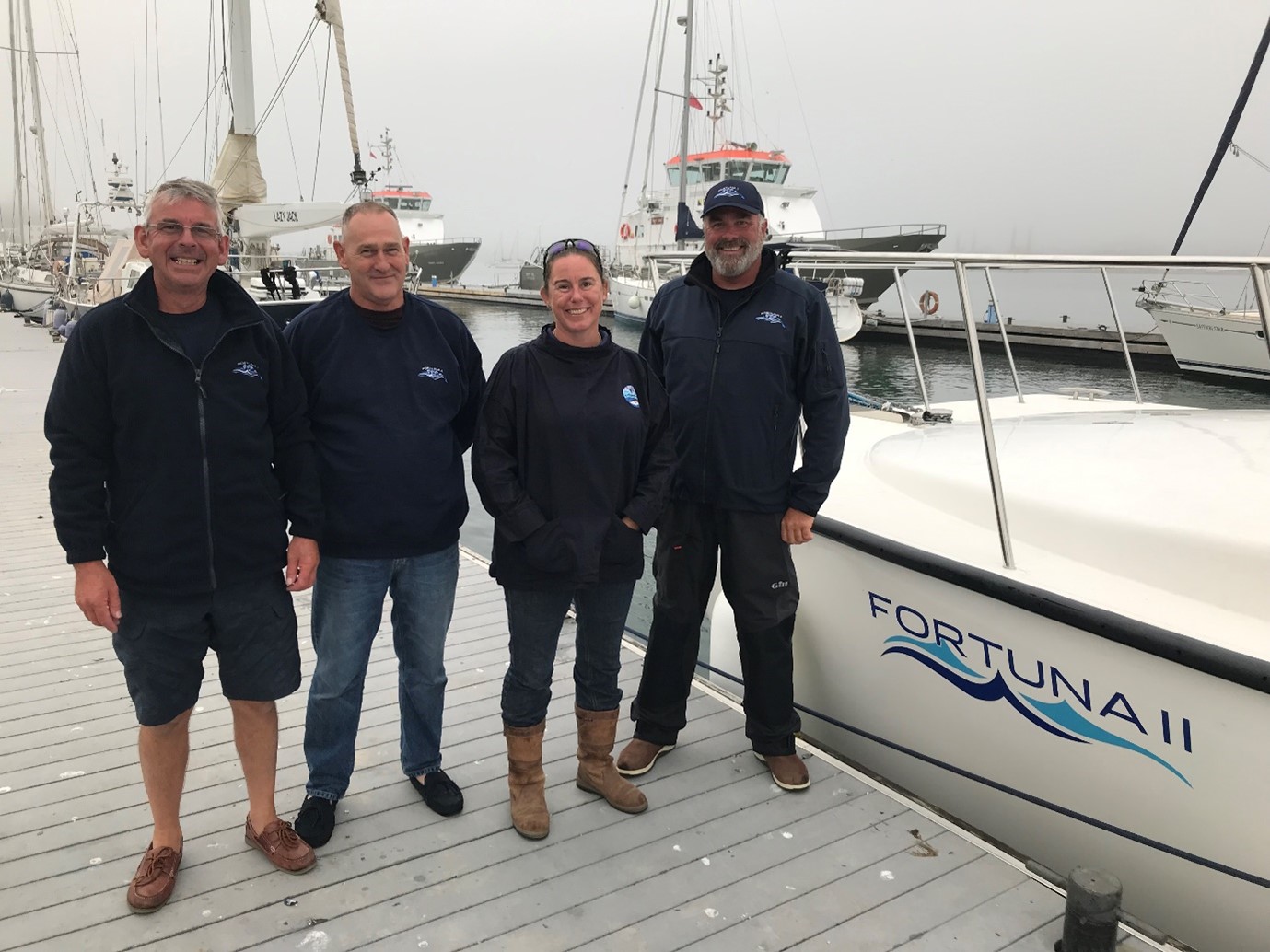 fishermen and Cefas staff standing by a boat