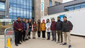 A group of people stood outside a building smiling