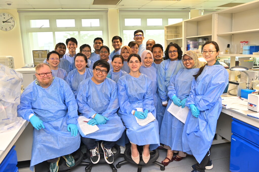 a group photo of people in lab coats
