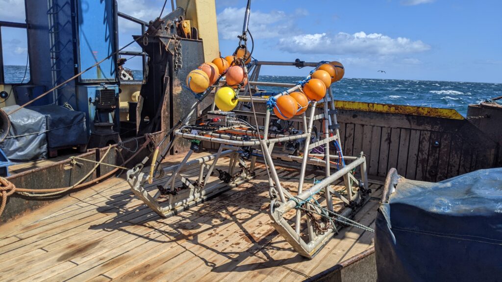 A sledge to use in the survey on the vessel back deck with the sea in the background
