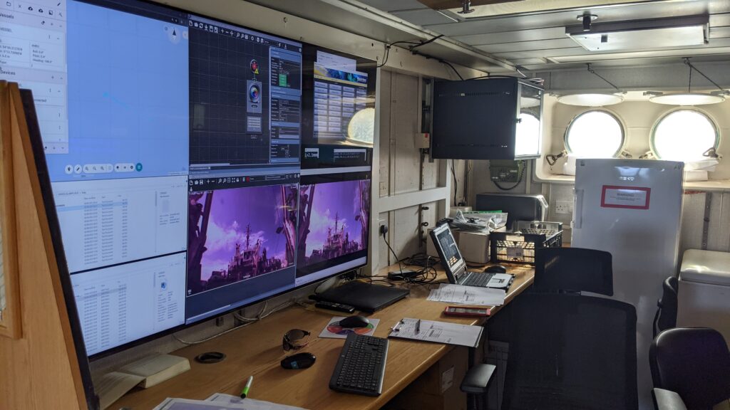 a range of TV screens showing video, maps and other information for the survey