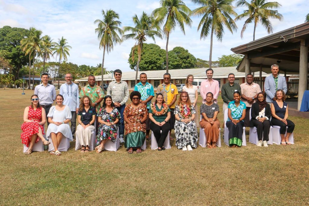 group og people with palm trees behind them